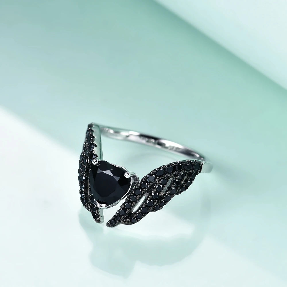 Sterling silver ring with a heart-shaped black gemstone flanked by pavé-set wing-like details, from the Ali Nere design.