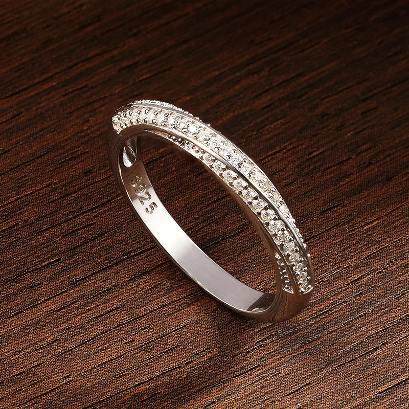 Slim silver ring featuring two parallel rows of small white stones, forming a subtle twist in the center, from the Bianco Nero collection.