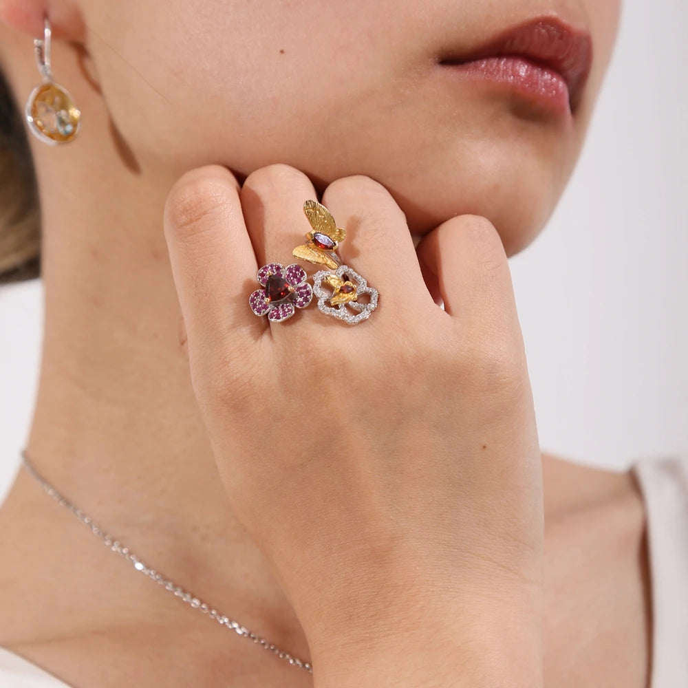 Open floral ring with red gemstone flowers and butterflies in silver and gold tones from the Rossa Collection.