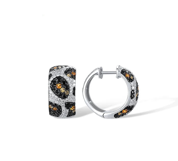 Matching jewelry set with leopard-inspired design in silver and gemstone accents, including ring and earrings, titled Pardus Lux.