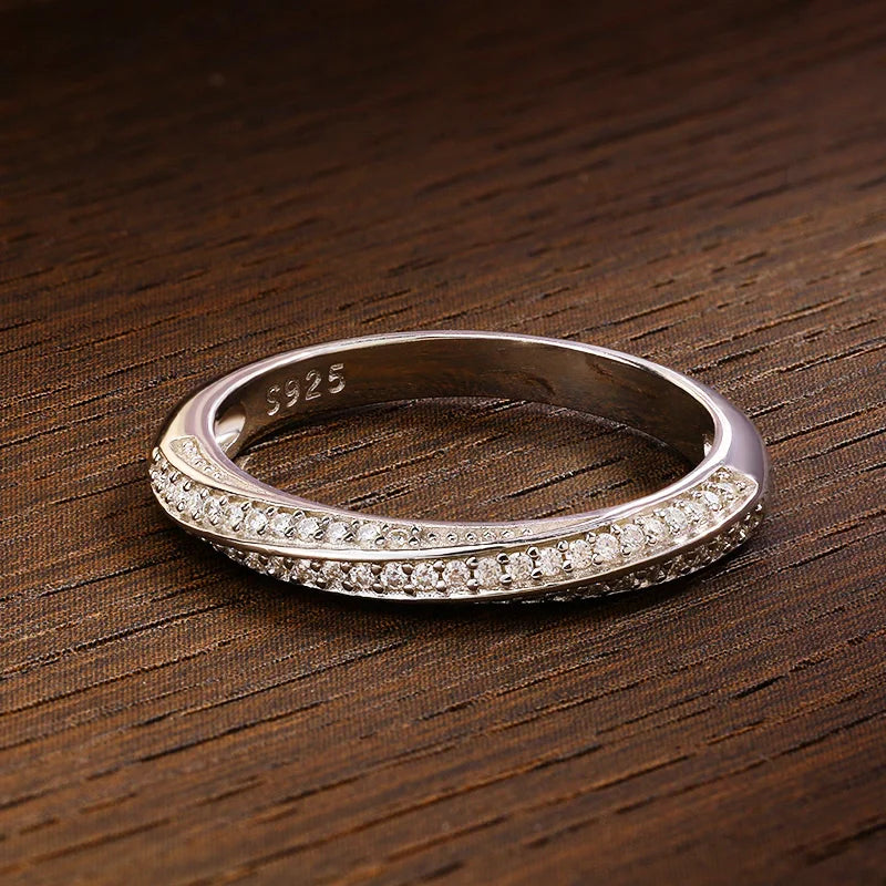 Slim silver ring featuring two parallel rows of small white stones, forming a subtle twist in the center, from the Bianco Nero collection.