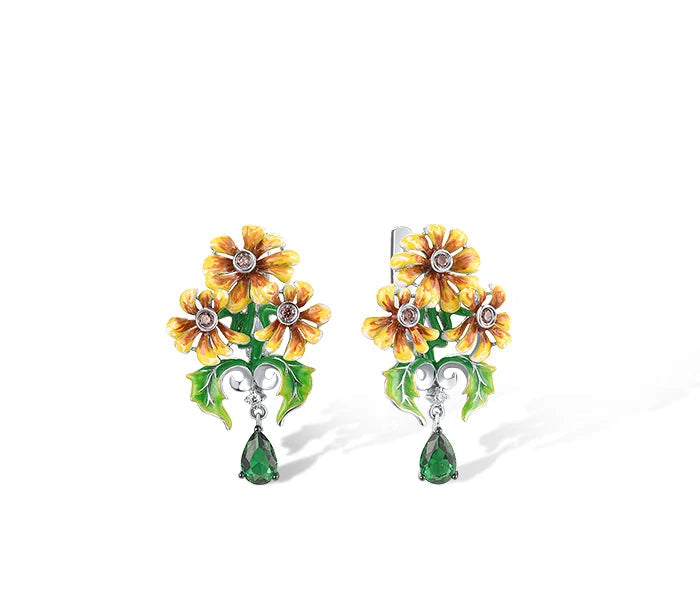 Jewelry set featuring yellow-orange flowers with green enamel leaves and teardrop green gemstone dangles