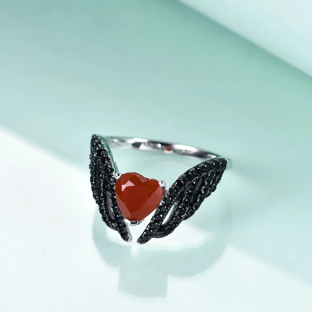 Sterling silver ring with a heart-shaped black gemstone flanked by pavé-set wing-like details, from the Ali Nere design.