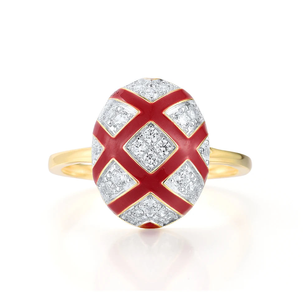 Gold ring with a domed top featuring a red enamel criss-cross design over pavé white stones.