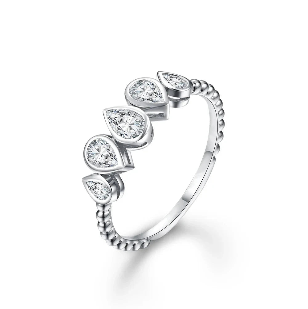 Delicate silver ring featuring five pear-cut stones in a row, with a beaded band design.