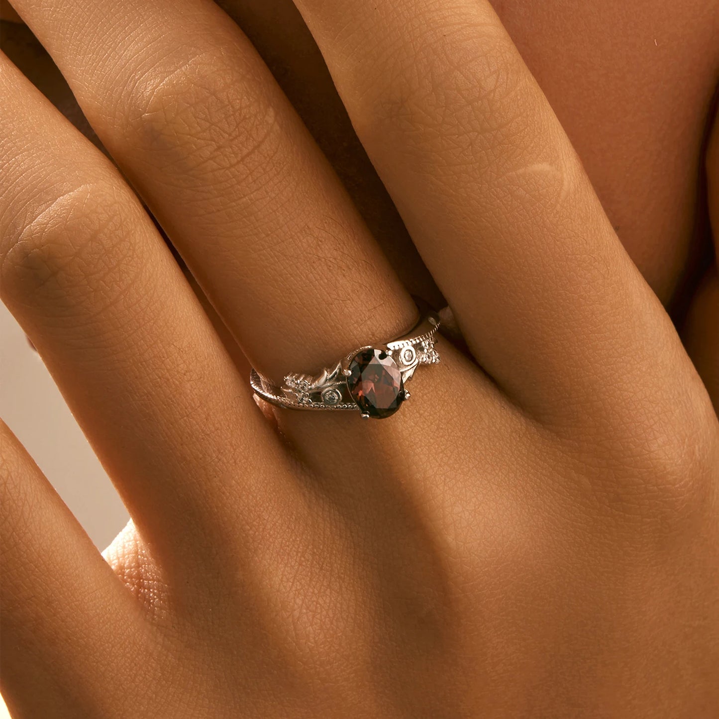 Sterling silver ring with a deep hazelnut-brown oval stone and decorative band