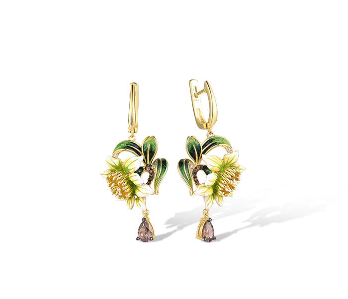Gold floral jewelry set with white and green enamel petals, gold detailing, and brown teardrop stones