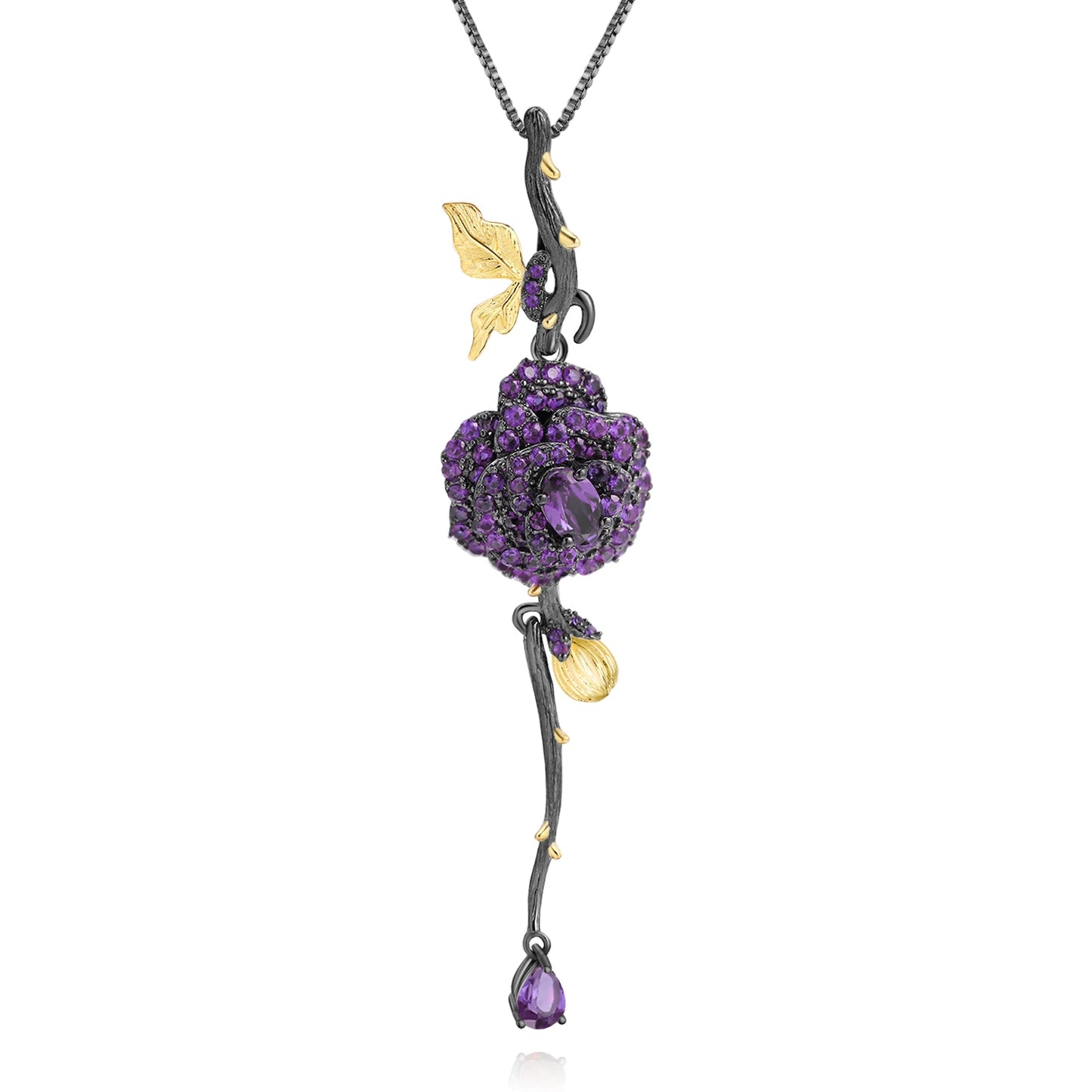 Pendant necklace with a dark rose-shaped bloom in ruby stones, accented by golden leaves and a delicate drop, from the Rossa Collection.