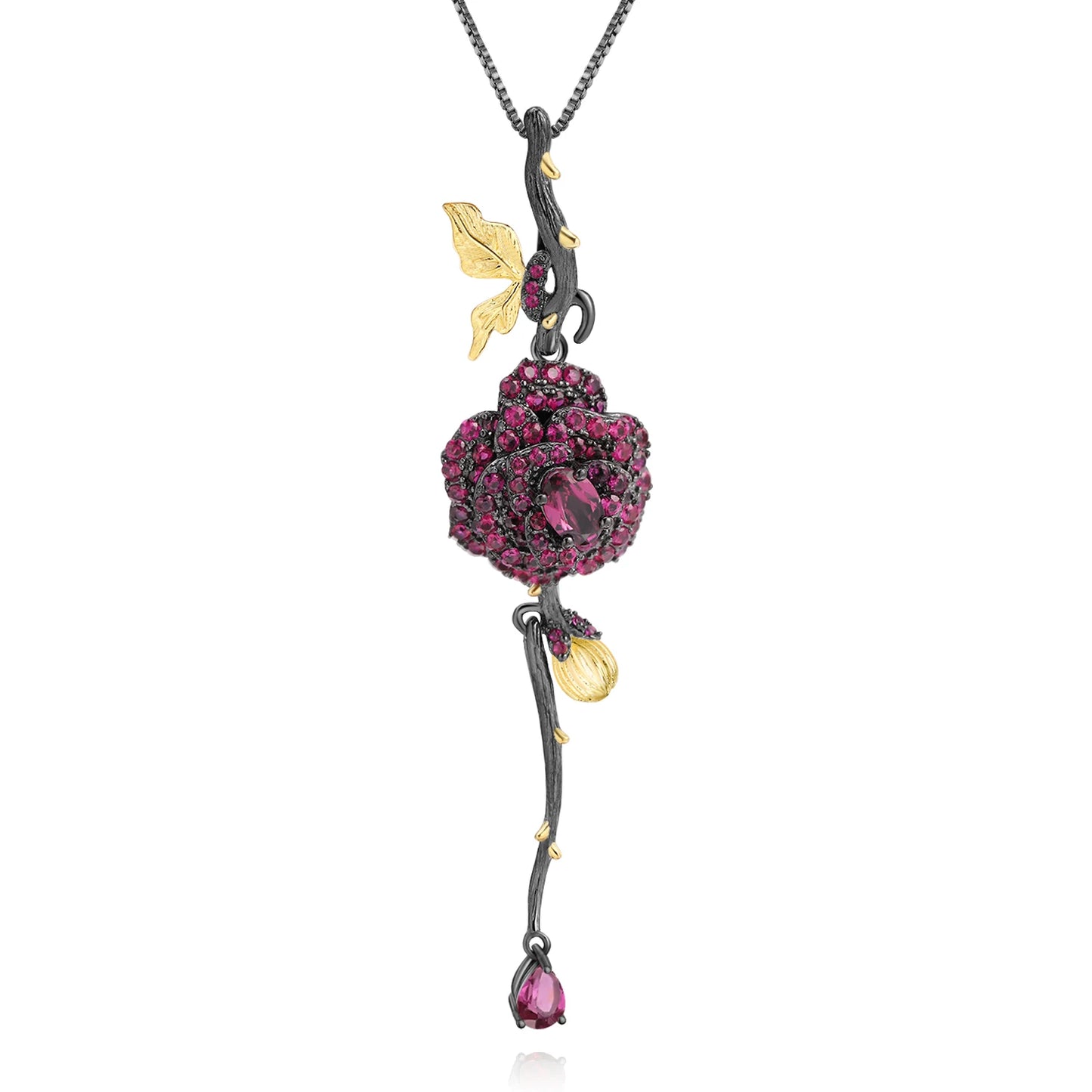Pendant necklace with a dark rose-shaped bloom in ruby stones, accented by golden leaves and a delicate drop, from the Rossa Collection.