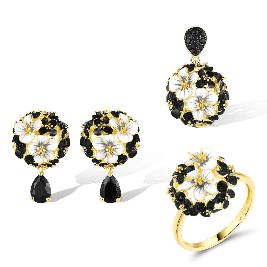 Matching jewelry set featuring black and white floral designs with gold settings, including earrings, pendant, and ring, titled Jacobaeus.