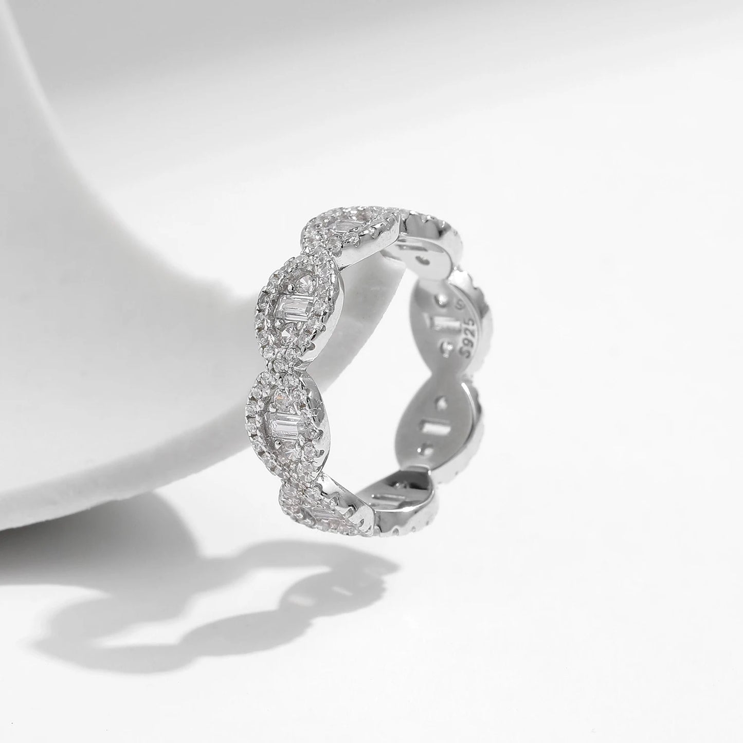 Silver eternity band with scalloped edges and baguette-cut cubic zirconia accents