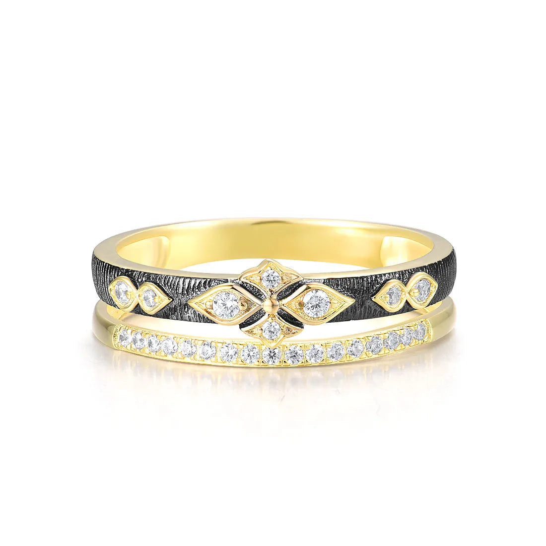 Gold ring with diamond accents and a contrasting textured black band featuring a geometric floral design.