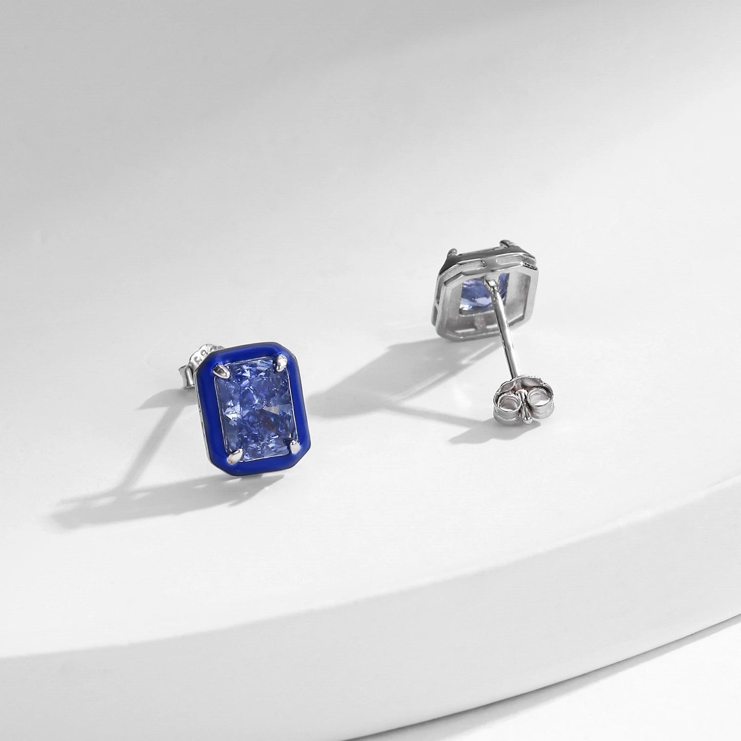 Set of three sterling silver stud earrings with deep blue, aqua, and lavender stones framed in coloured enamel