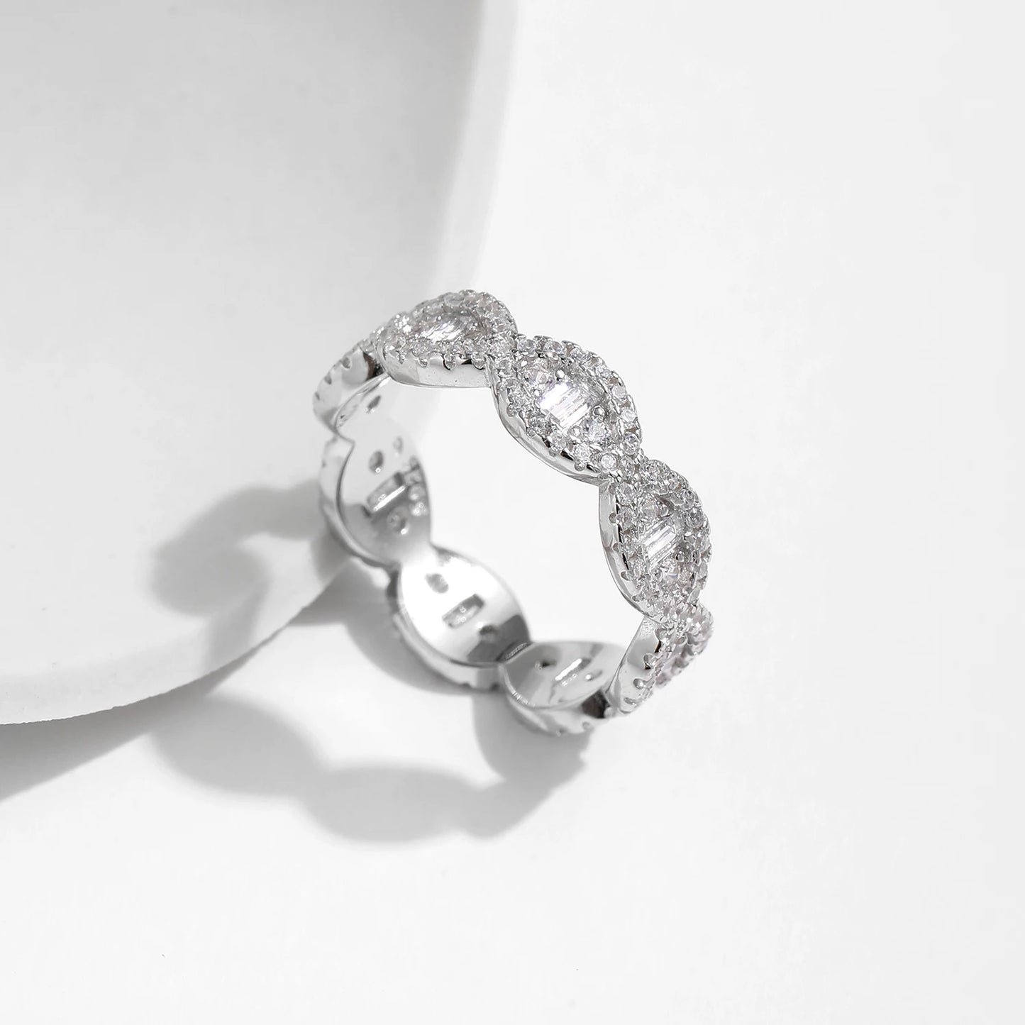 Silver eternity band with scalloped edges and baguette-cut cubic zirconia accents