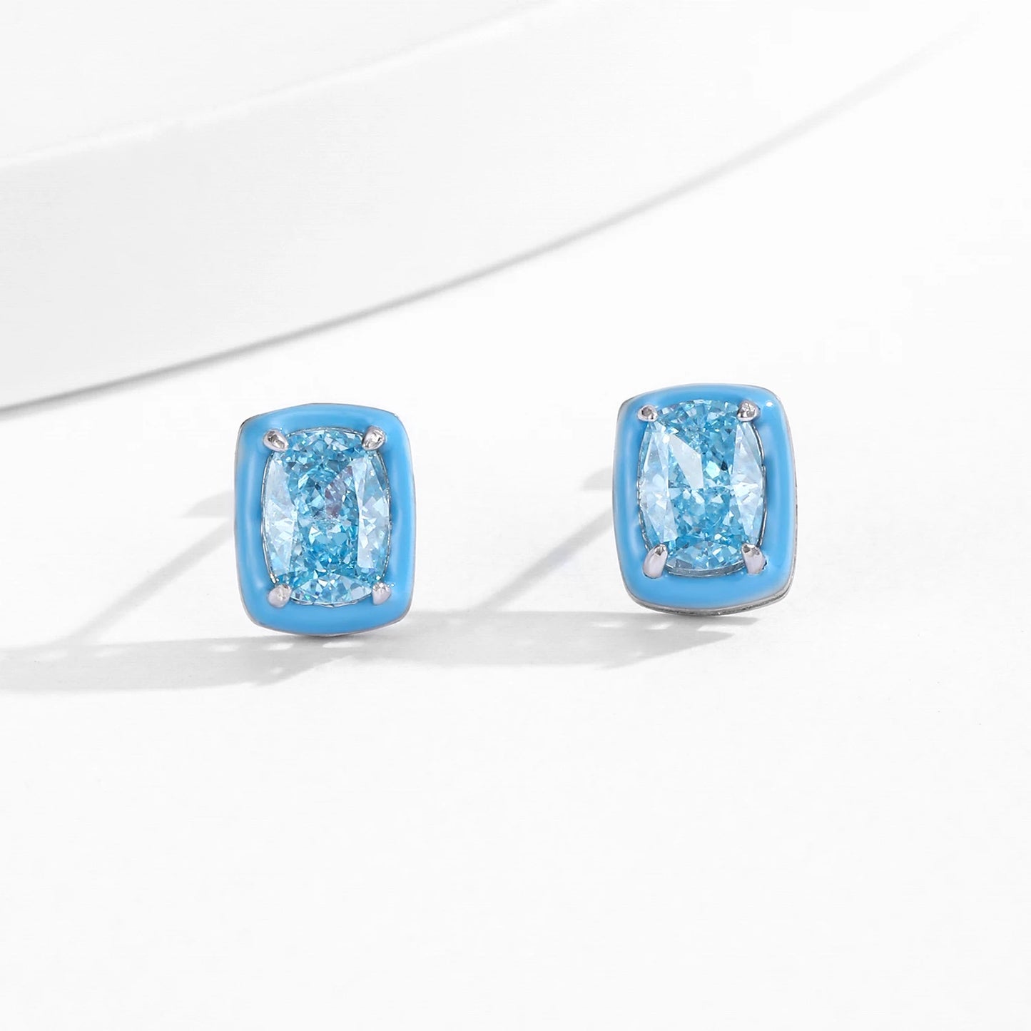 Set of three sterling silver stud earrings with deep blue, aqua, and lavender stones framed in coloured enamel