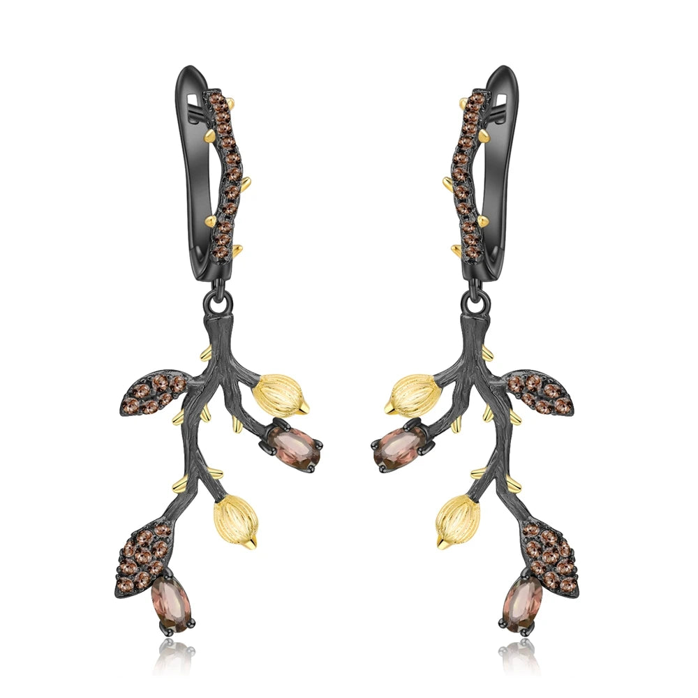 Botanical-inspired earrings with purple, green, and gold accents