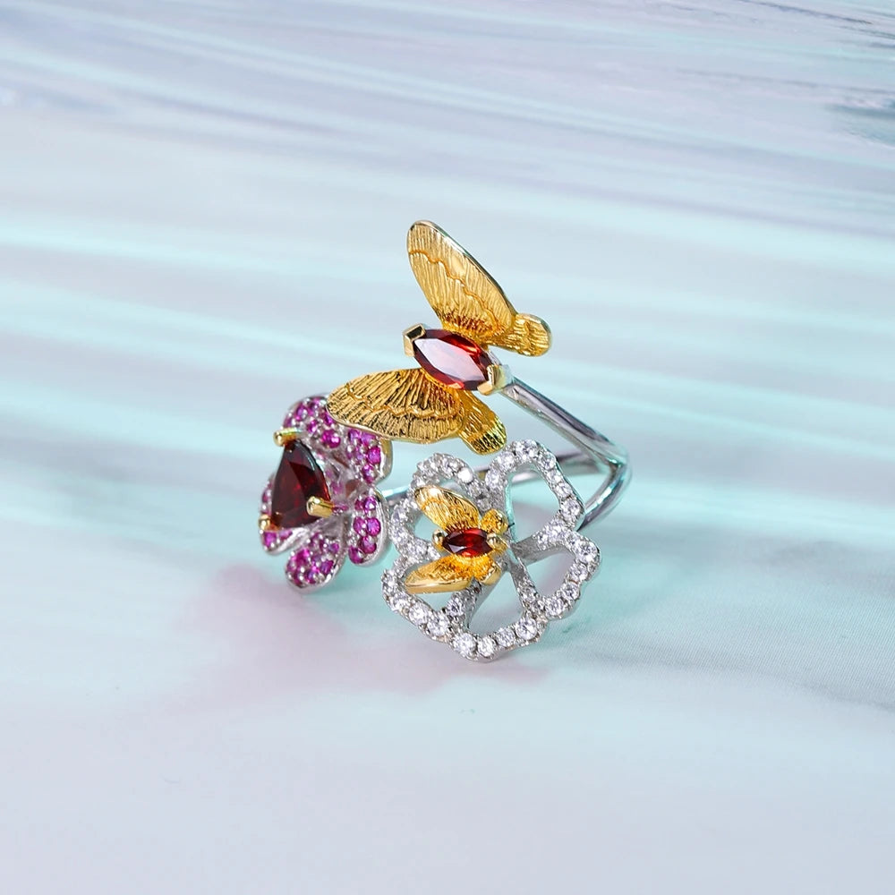Open floral ring with red gemstone flowers and butterflies in silver and gold tones from the Rossa Collection.
