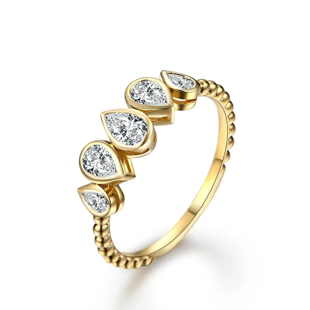 Delicate silver ring featuring five pear-cut stones in a row, with a beaded band design.