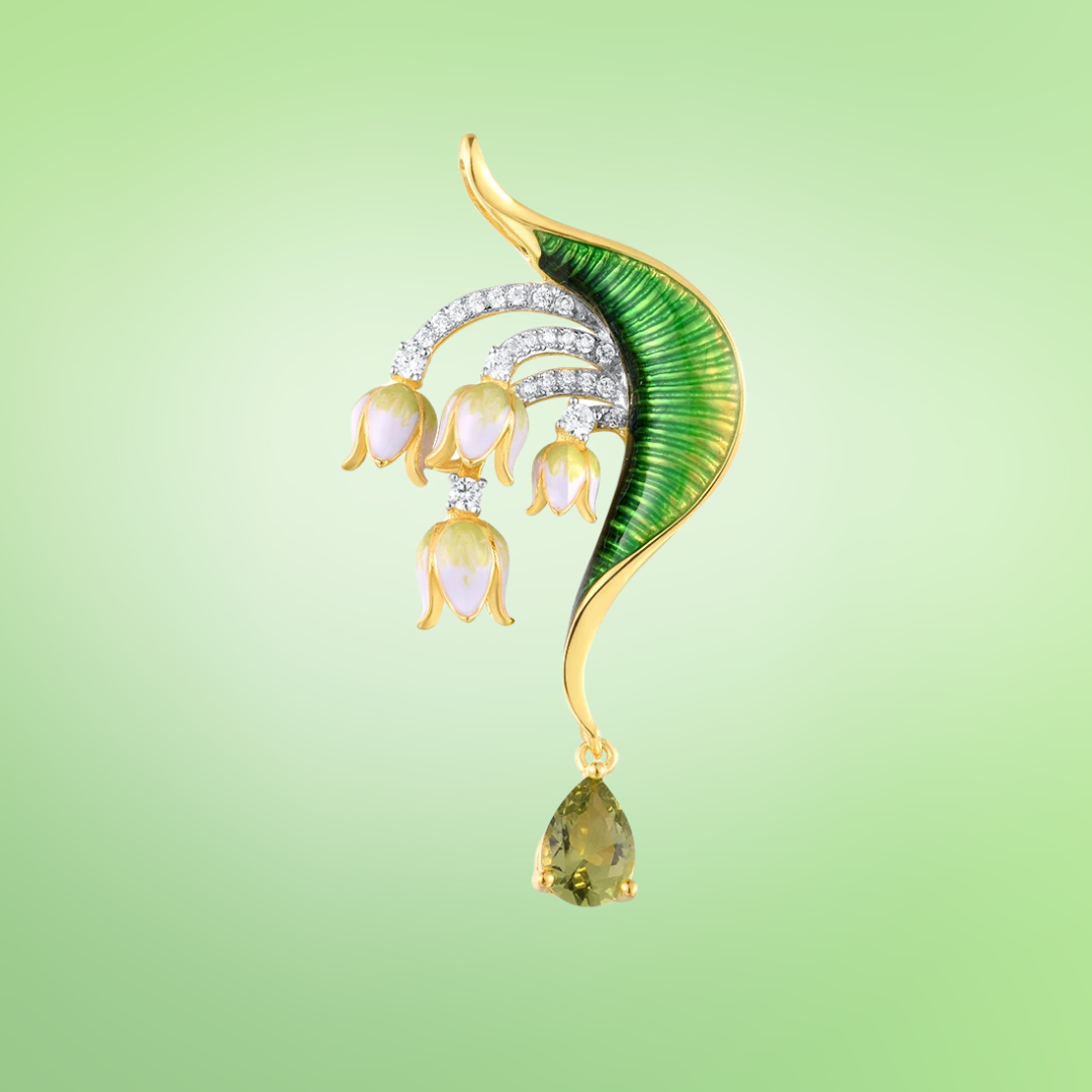 Gold brooch with green enamel leaf, white and pink floral drops, and teardrop green gemstone