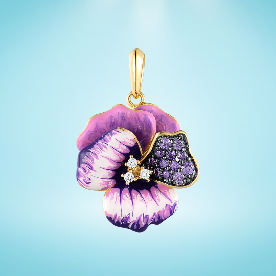 Gold floral pendant with layered violet and cream enamel petals, accented by purple pavé stones and small white crystals, on a light blue background