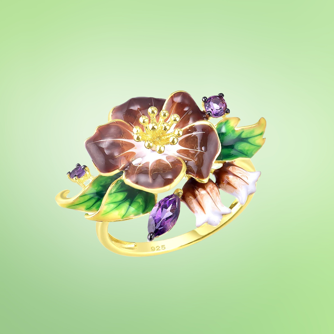Gold ring with deep purple flower enamel, green leaves, and amethyst-like stones