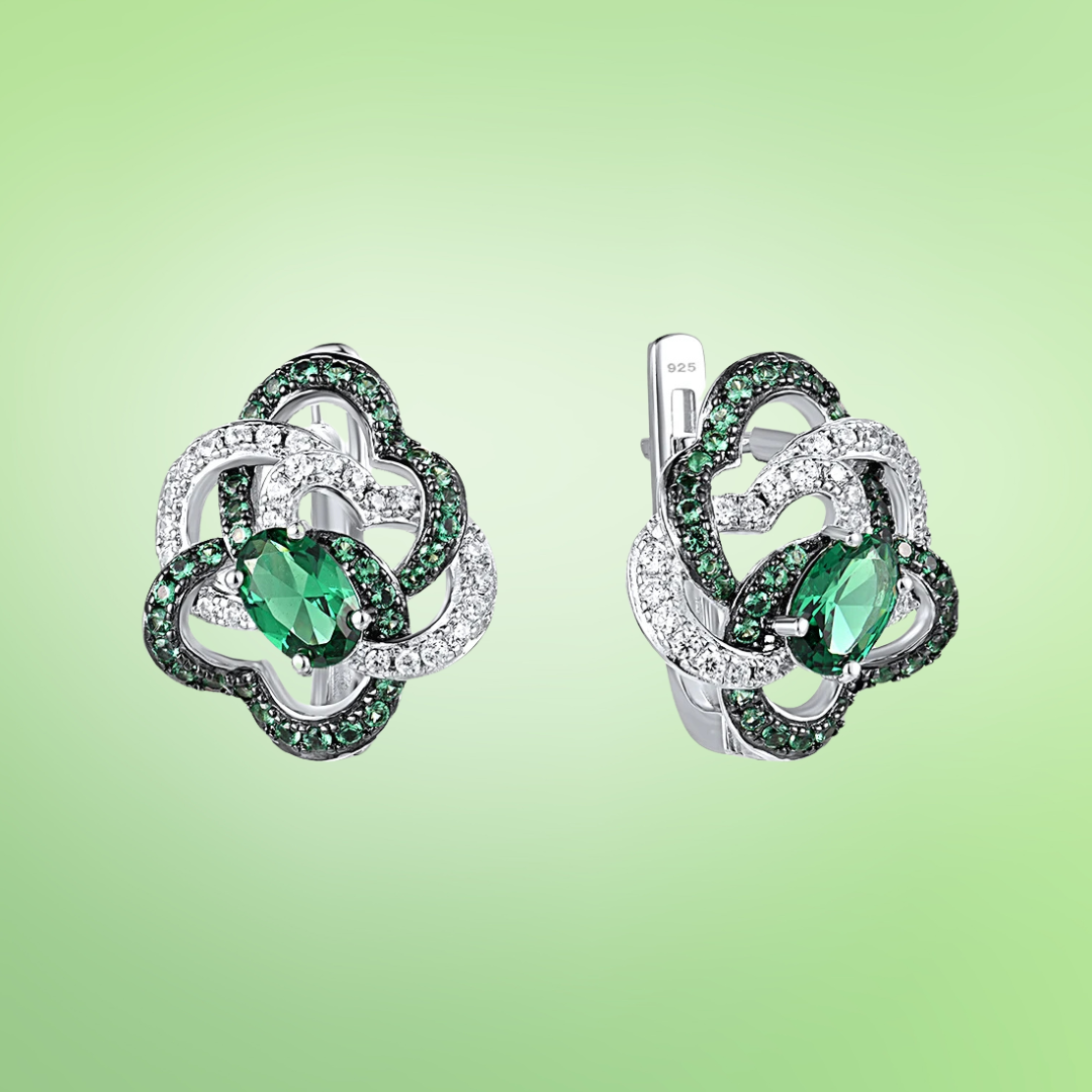 Silver earrings with interlocking openwork loops, pavé-set in white and green stones and centered with a marquise green gem