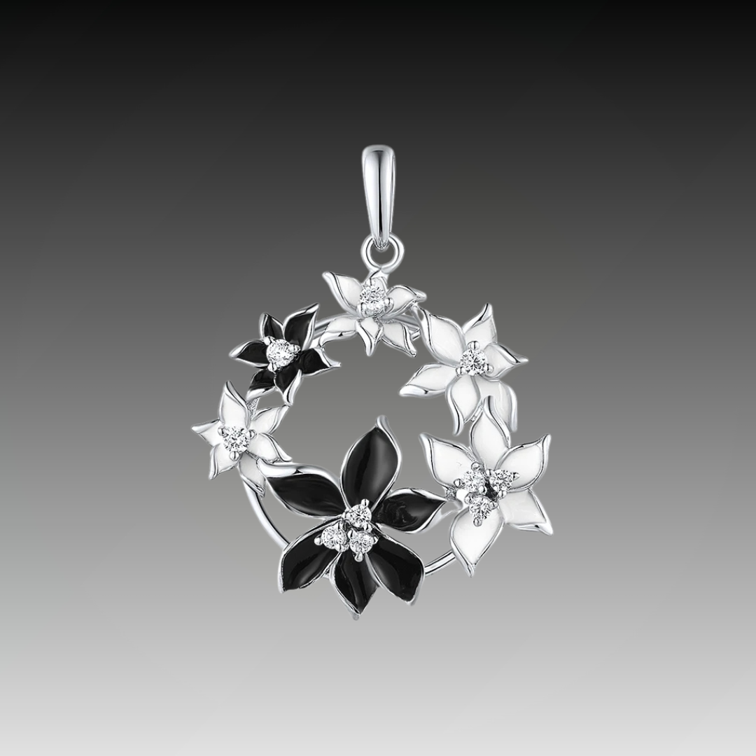 Pendant with alternating black and white floral elements arranged in a circular wreath