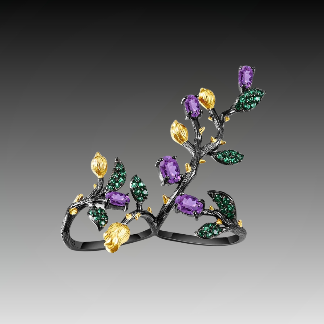 Double-finger black ring shaped like a flowering branch with purple, green, and gold detailing