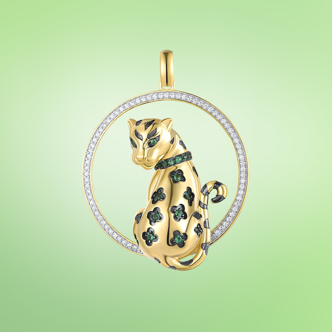 Gold leopard pendant with green eyes and black enamel spots inside a crystal-studded circle