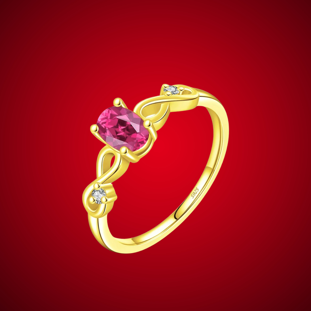Gold-plated ring with an oval pink gemstone and twisted infinity-style band