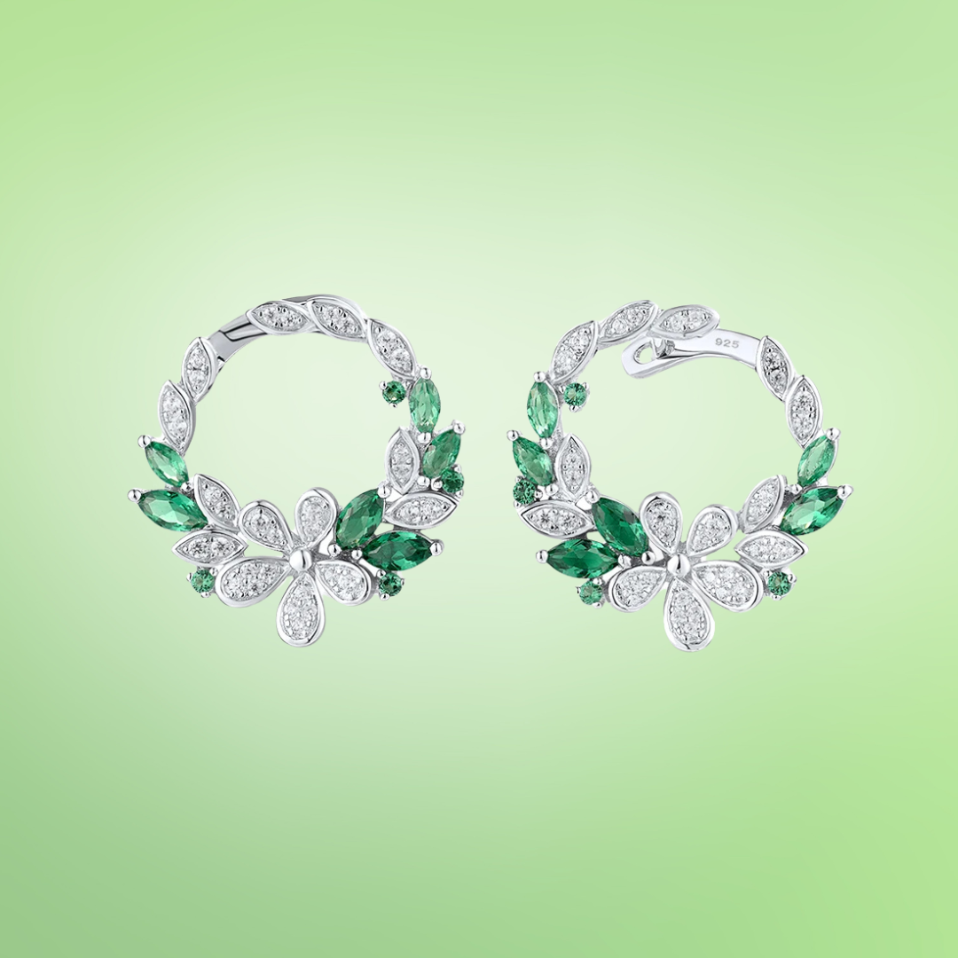 Silver and green gemstone hoop earrings with floral clover-inspired accents