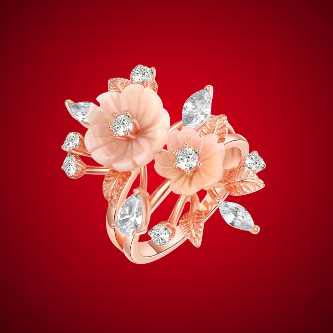 Begonia ring with carved peach-toned flowers, white stones, and rose gold leaves in an intricate botanical design.
