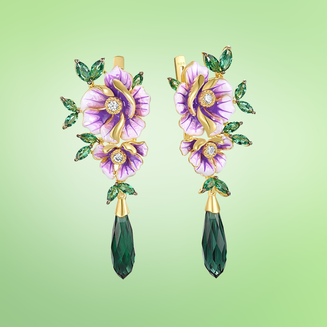Gold earrings with purple enamel flowers, green marquise leaves, and elongated dark green crystal drops