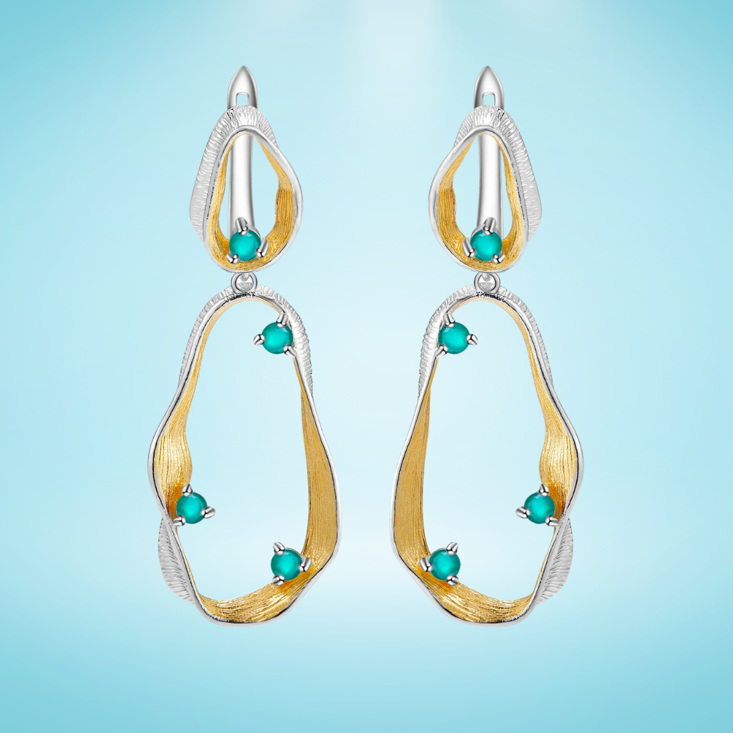 Dangling earrings with flowing gold and silver forms set with turquoise-colored stones