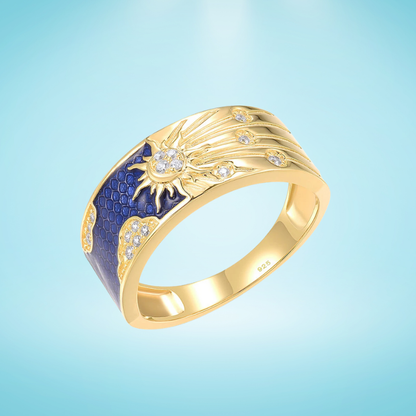 Gold-plated silver ring with a radiant sunburst design, sparkling stones, and deep blue enamel detailing


