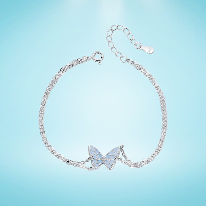Delicate silver bracelet with a central opal butterfly charm and fine double chain

