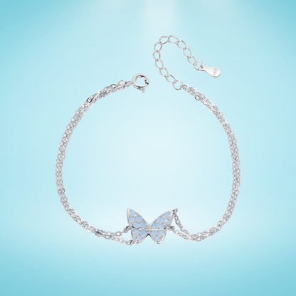 Delicate silver bracelet with a central opal butterfly charm and fine double chain

