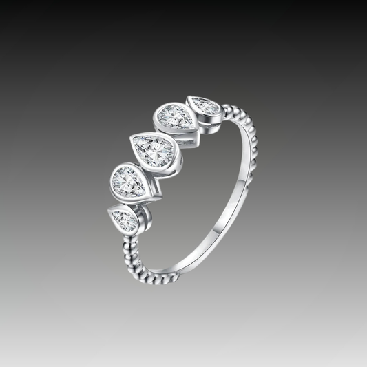 Delicate silver ring featuring five pear-cut stones in a row, with a beaded band design.


