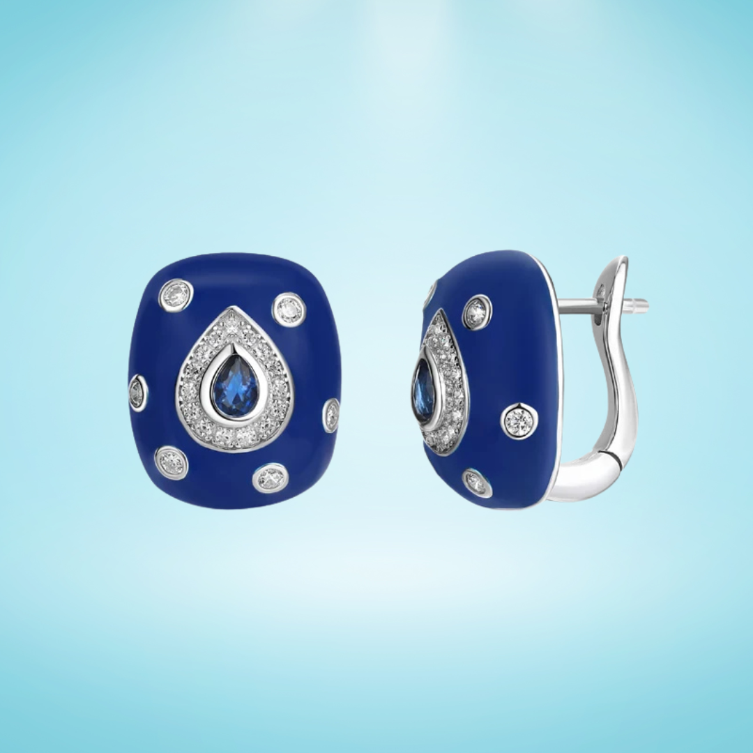 Bold blue enamel earrings with central teardrop-shaped sapphire stones framed by white zircon pavé on a silver base.

