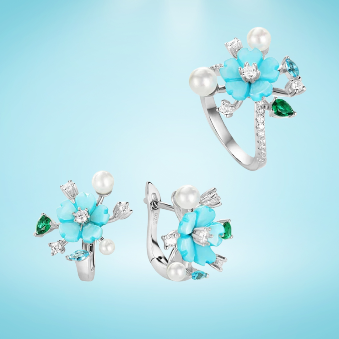 Turquoise flower jewelry set with pearls, green and blue gemstones, and white zircon accents on silver.

