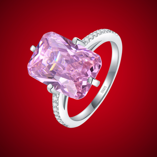 Sterling silver ring with a large rectangular-cut pink gemstone and pavé-set accents along the band.

