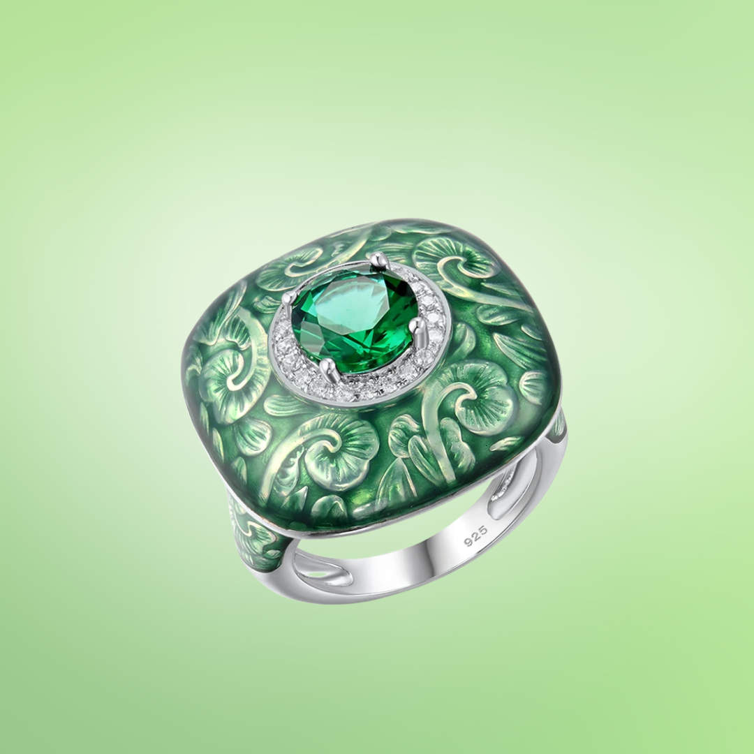 Square green enamel ring with engraved floral design and central green gemstone

