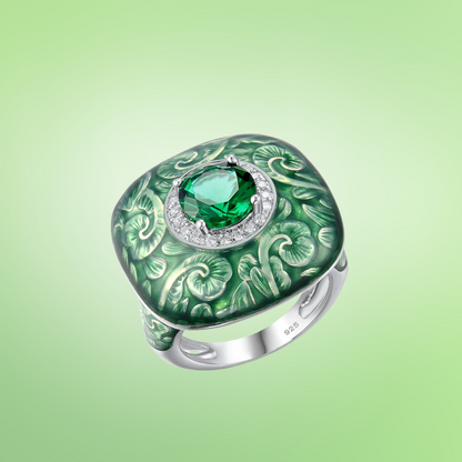 Square green enamel ring with engraved floral design and central green gemstone

