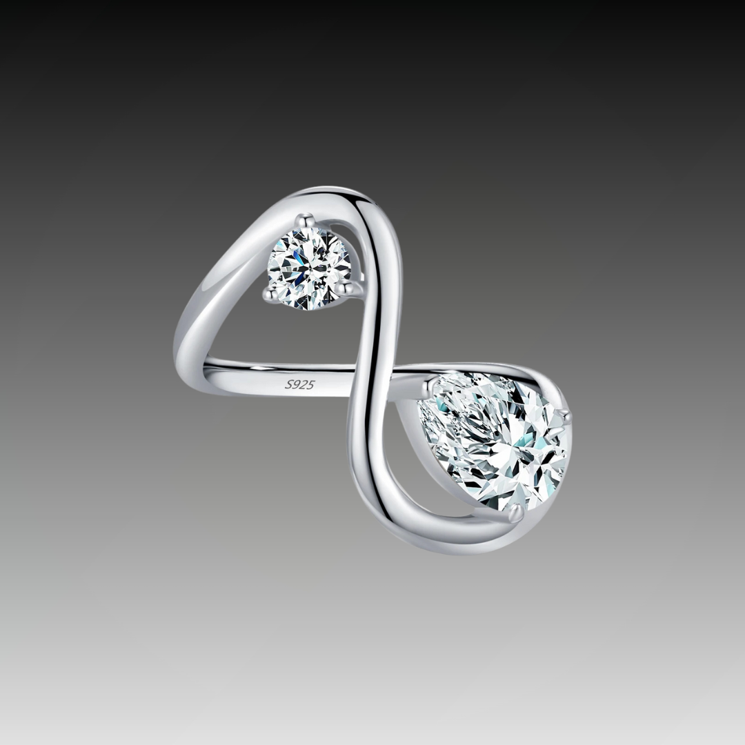 Sterling silver bypass ring featuring two white round-cut stones in a modern flowing design

