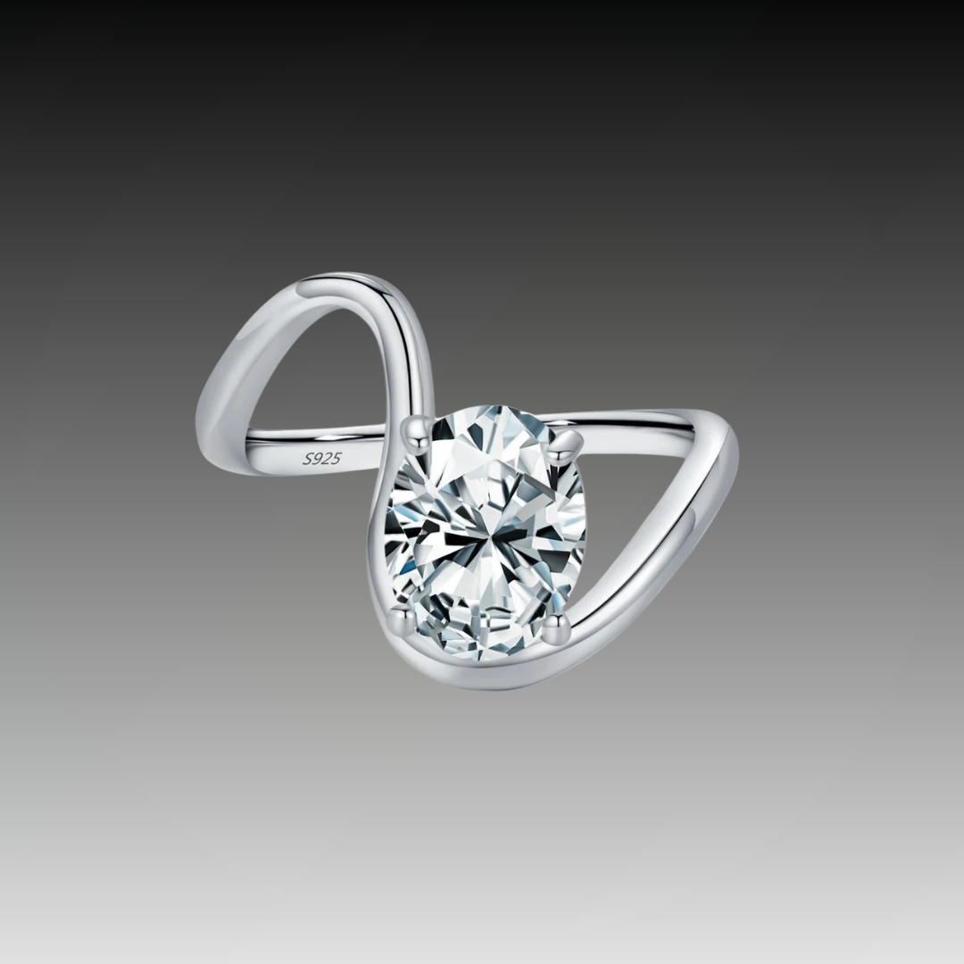 Open silver ring with a triangular wrap design, featuring a prominent oval white stone at its center, from the Bianco Nero collection.

