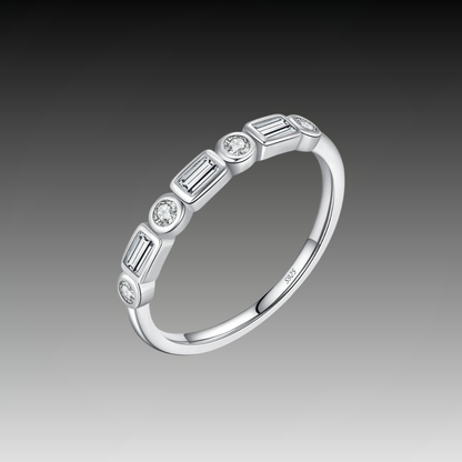 Silver ring featuring alternating round and baguette-cut white stones in a half-band setting.

