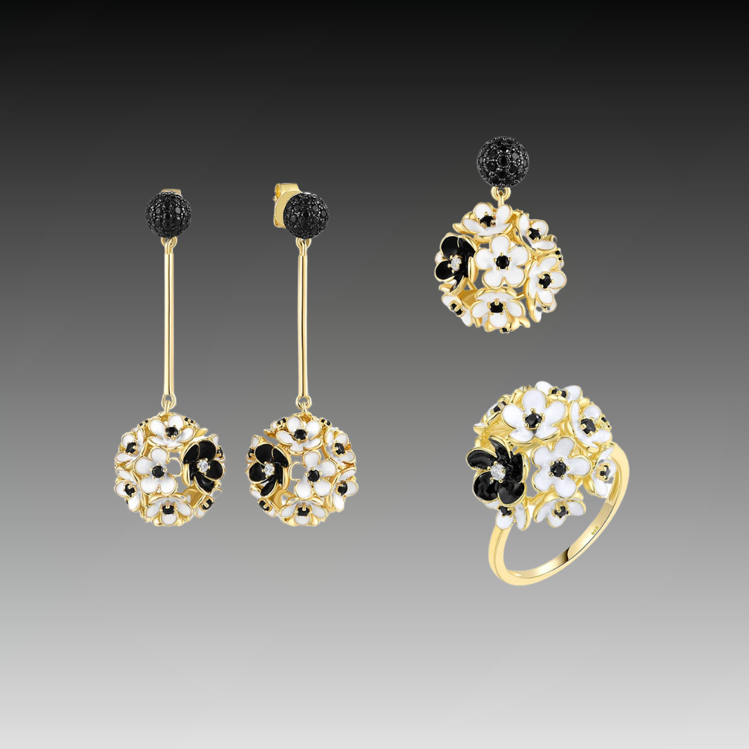 Fiore Scuro jewelry set featuring gold-tone earrings, ring, and pendant with white and black floral detailing from the Bianco Nero collection.

