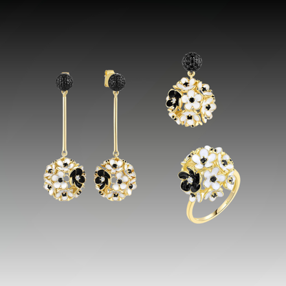 Fiore Scuro jewelry set featuring gold-tone earrings, ring, and pendant with white and black floral detailing from the Bianco Nero collection.

