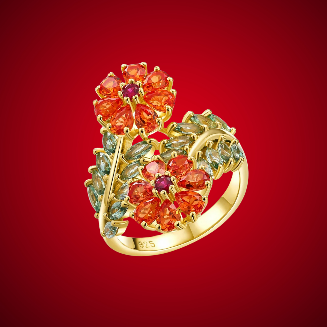 Gold ring with vibrant orange floral gemstones and soft green leaf-shaped stones, Fiore di Cristallo from the Rossa Collection.

