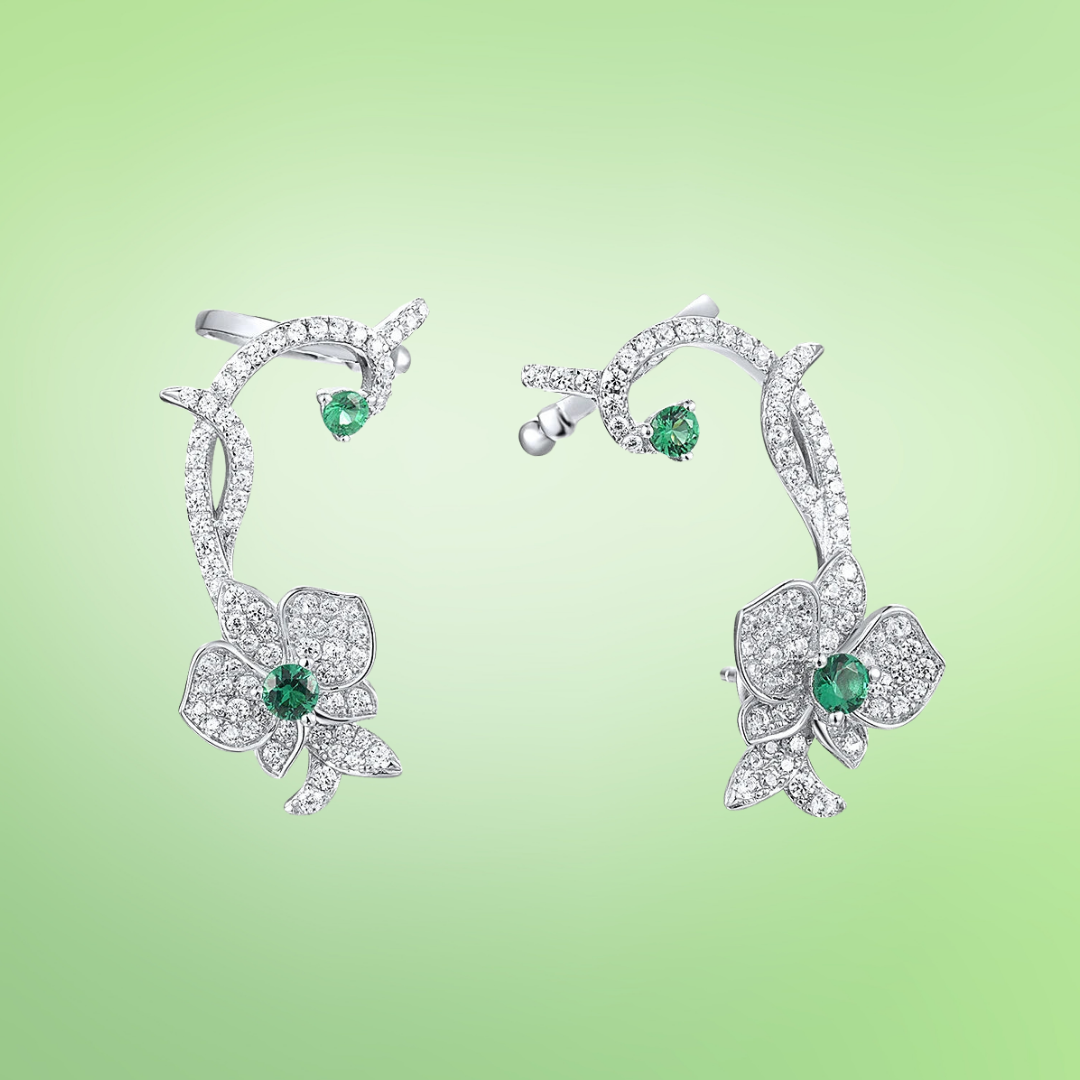 Floral vine-inspired earrings with sparkling white pavé and green gemstone accents

